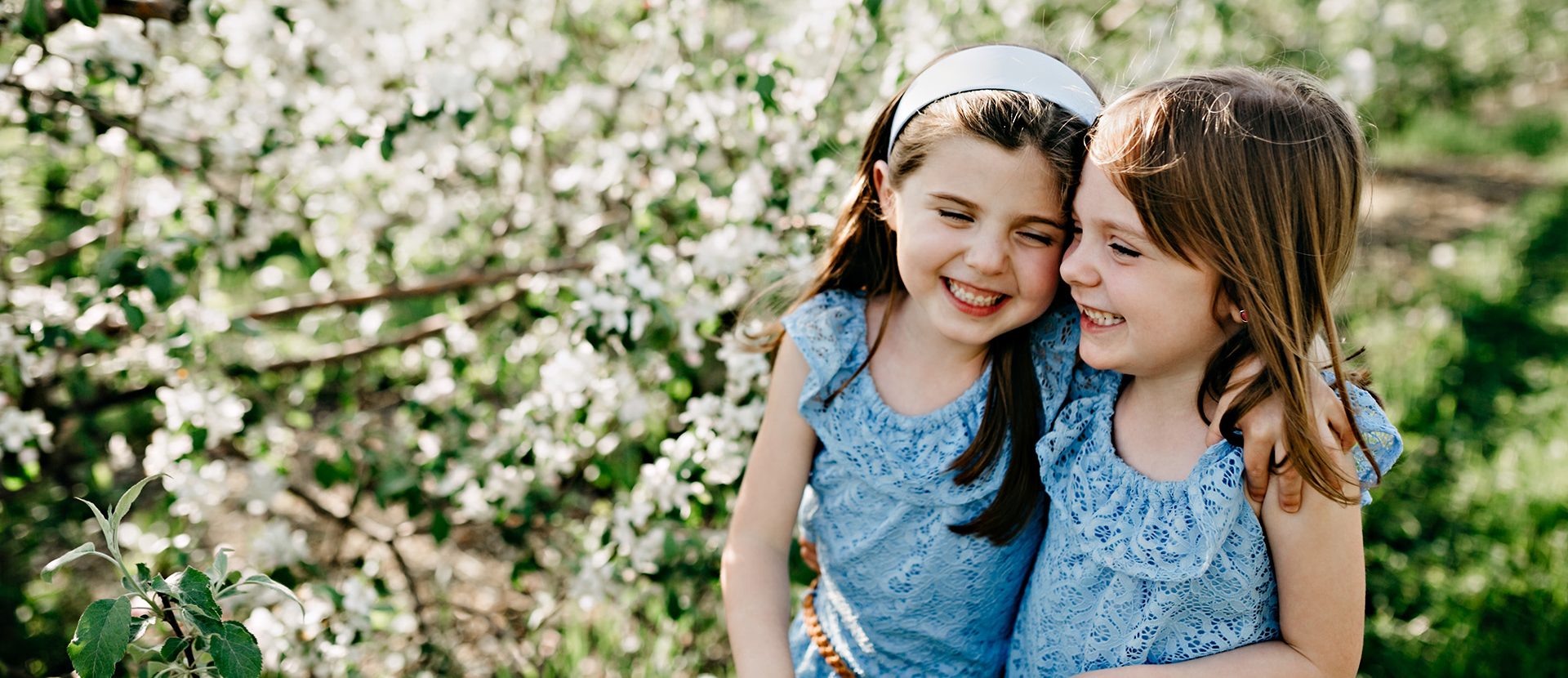 girls smiling and hugging